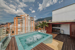 Jacuzzi privado al aire libre en amplia terraza con zona BBQ, parte del penthouse en venta en Milla de Oro, sector exclusivo de Medellín